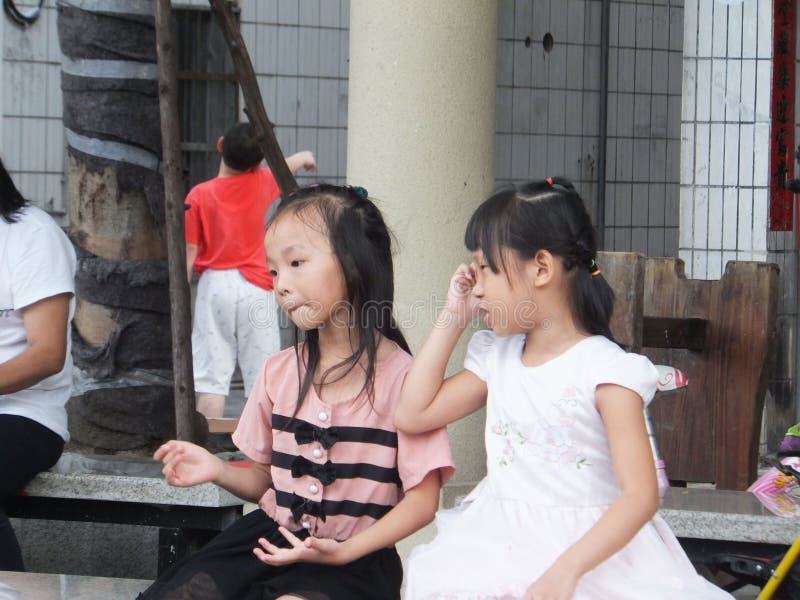 Shenzhen, China: little girls are playing, interesting scenes stock photos Shenzhen, China: little girls are playing, interesting scenes stock photos