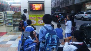 Shenzhen China Primary School Students Watch TV In Front Of Shops 