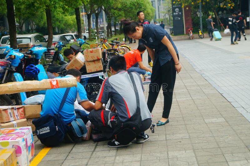 Shenzhen, China: on the Sidewalk Courier Company Employees are ...