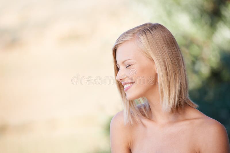 Shes an all-natural beauty. A beautiful young woman smiling while outdoors.