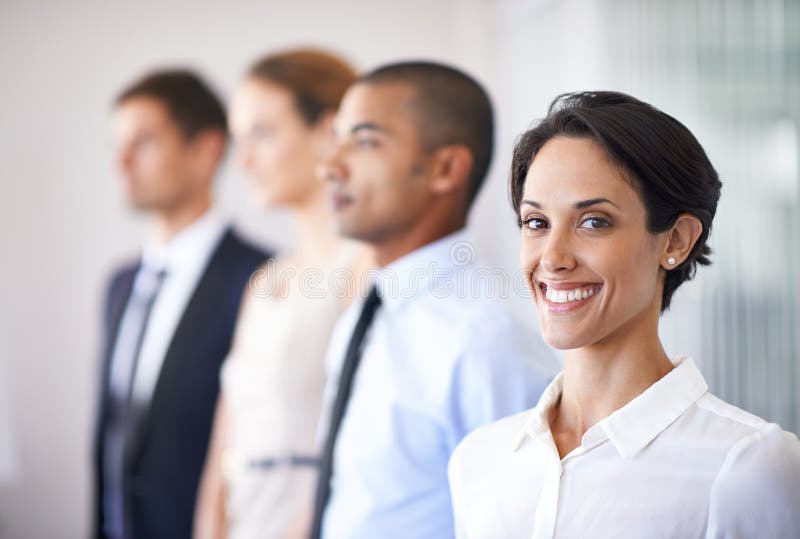 Shes beaming about business. Group of business colleagues in the office. royalty free stock photography