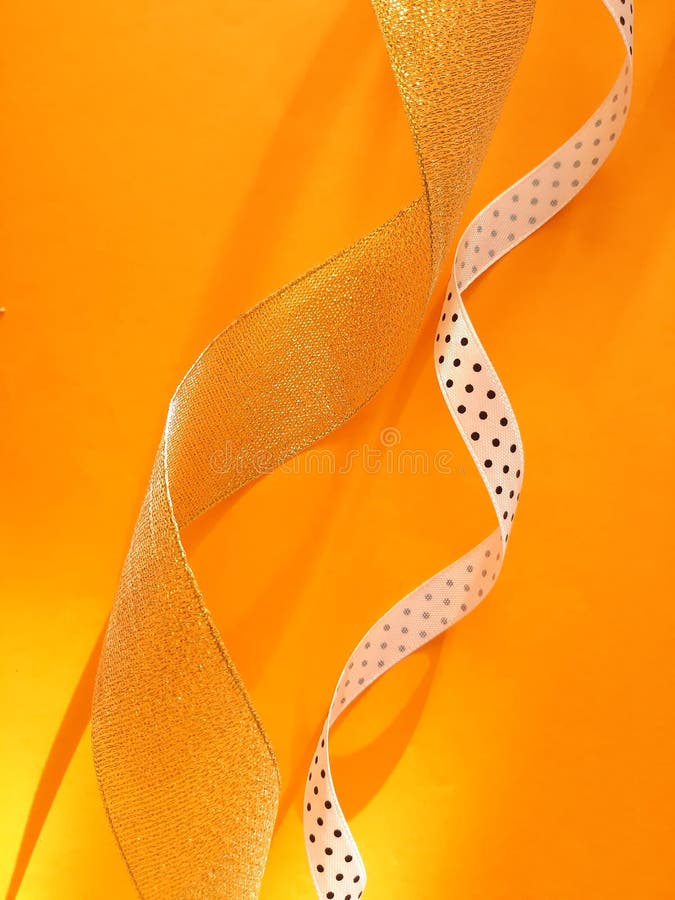 Shining Ribbons on an Orange Background Stock Photo - Image of gift