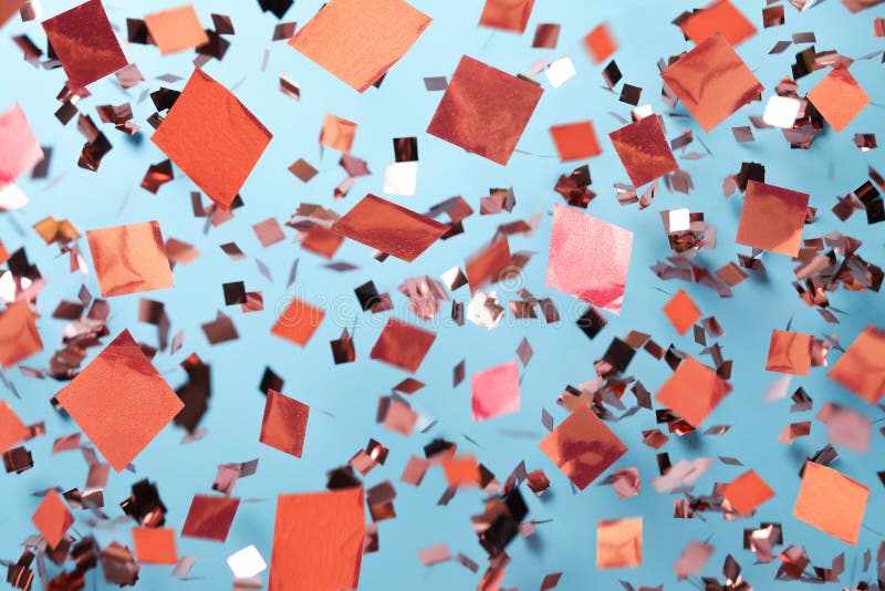 Shiny Pink Confetti Falling Down on Light Blue Background Stock Image
