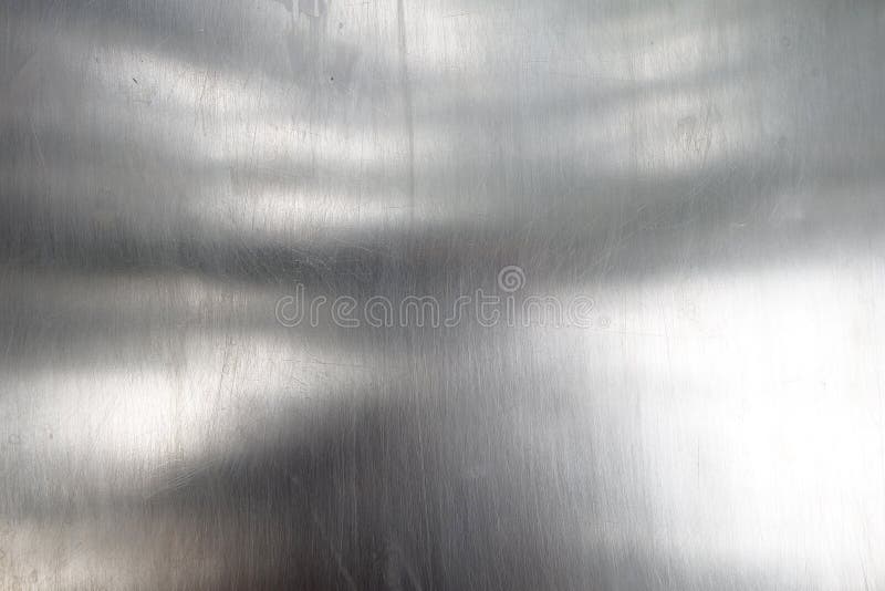 shiny and reflective surface of gray aluminum metal sheet, close-up silver stainless steel plate texture with tiny scratches