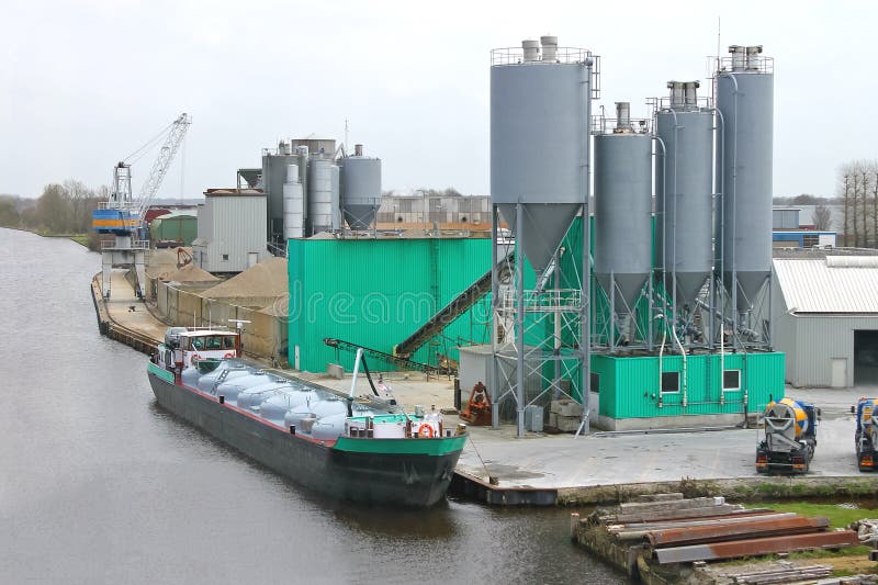 Ship In Harbor Of The Cement Plant. Stock Photo - Image of factory