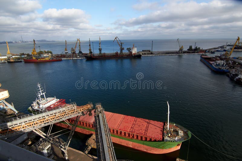 Ship mooring. Big grain terminal at seaport. Preparation of cereals bulk transshipment to vessel. Loading grain crops on