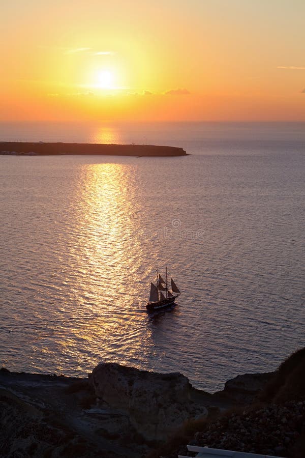 Ship sailing at sunset