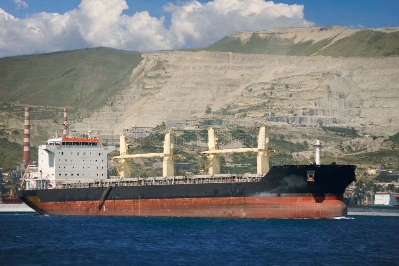 Ship in the seaport against the mountains