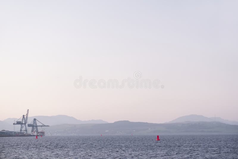 Shipbuilding port and ships at dock with crane at sunset coastal view stock photography