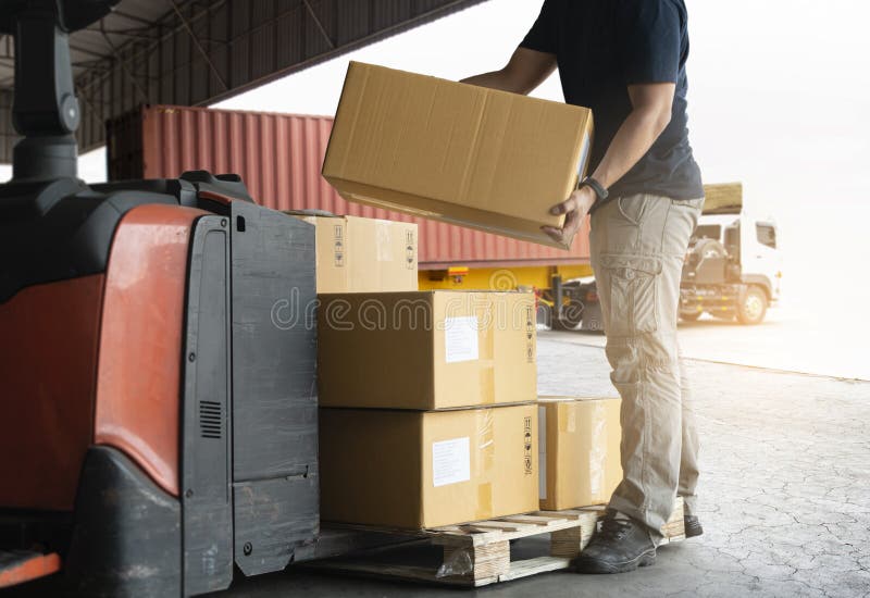 Shipment boxes. Warehouse worker lifting cardboard boxes stack on pallet rack. Cargo export. Distribution warrehousing transportat stock image