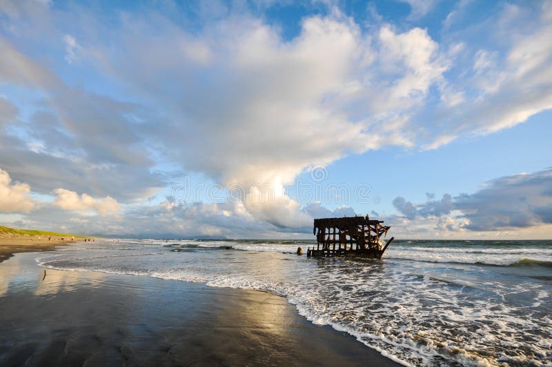 Shipwreck is pounded by waves on beach