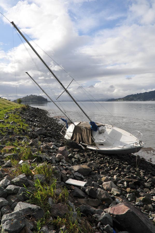 Shipwreck on shore with ground underneath boat