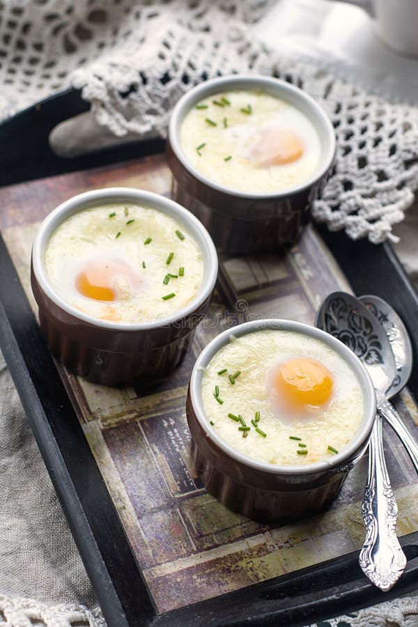 Shirred baked eggs for breakfast with coffee. Shirred baked eggs for breakfast with coffee