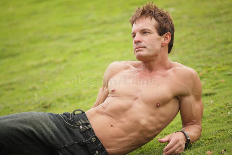 Shirtless man relaxing on the grass