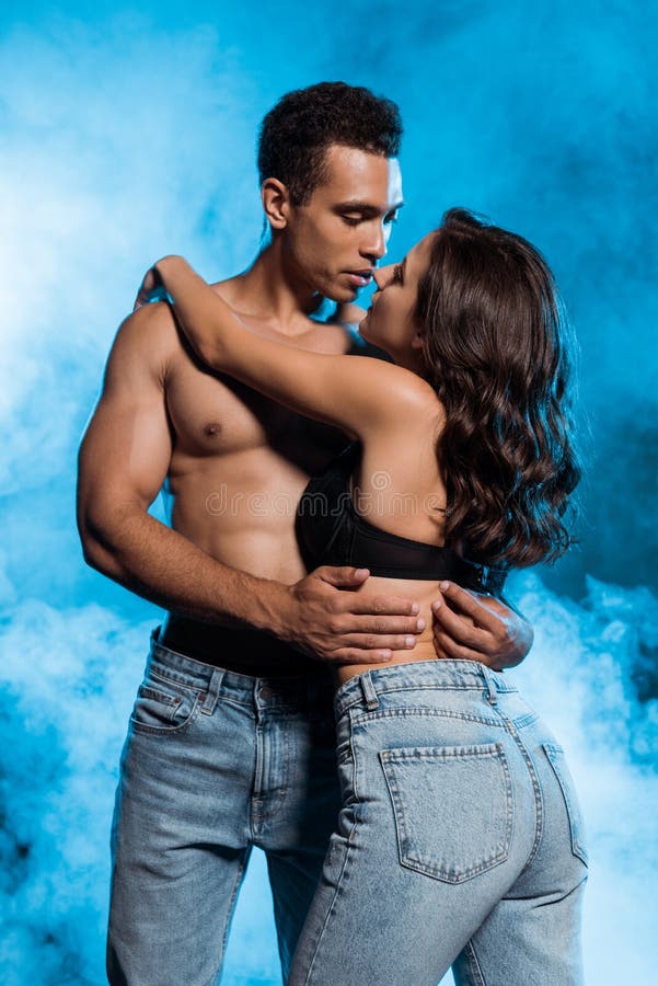 Shirtless Man Hugging Young Woman Standing in Lace Bra on Blue with Smoke.  Stock Image - Image of girl, together: 207979317