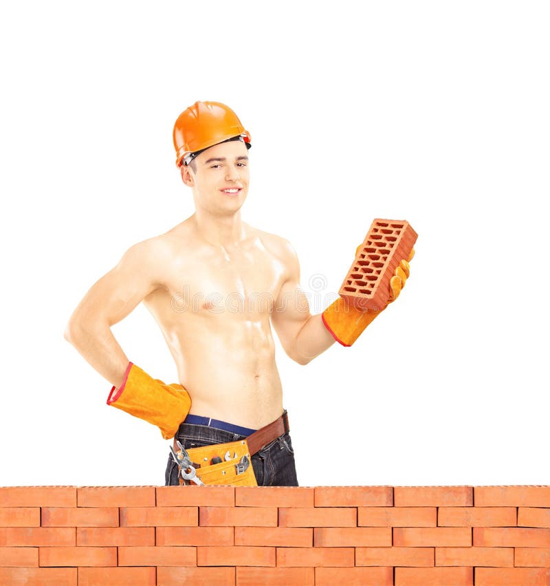 Shirtless muscular male construction worker holding a brick