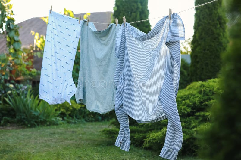 Shirts Drying on Washing Line at Backyard of House Stock Photo Image