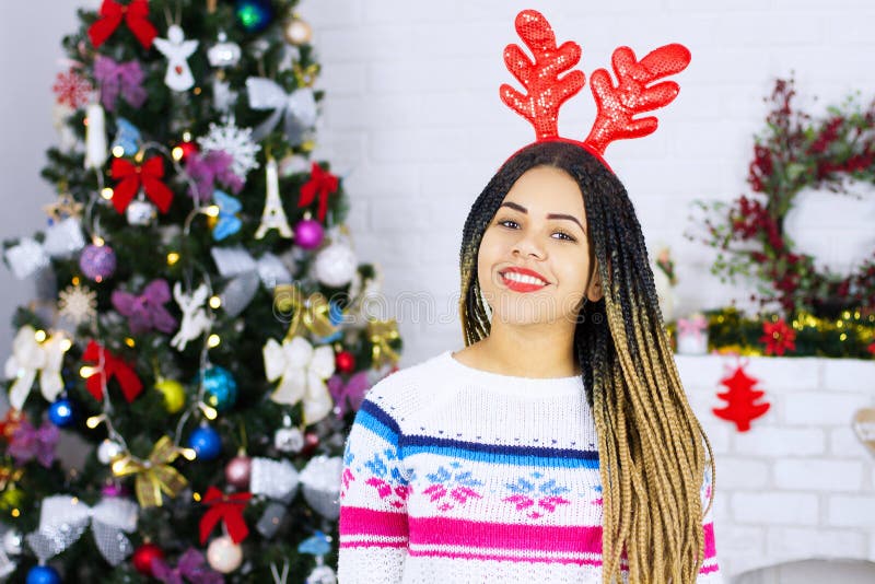 Shock happy excited african american young woman at Christmas tree home background. Happy New Year, Merry Christmas holidays. Gift stock image Shock happy excited african american young woman at Christmas tree home background. Happy New Year, Merry Christmas holidays. Gift stock image