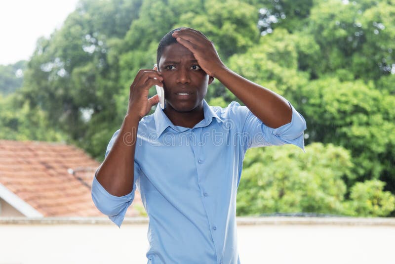 Shocked african american businessman at phone royalty free stock photos