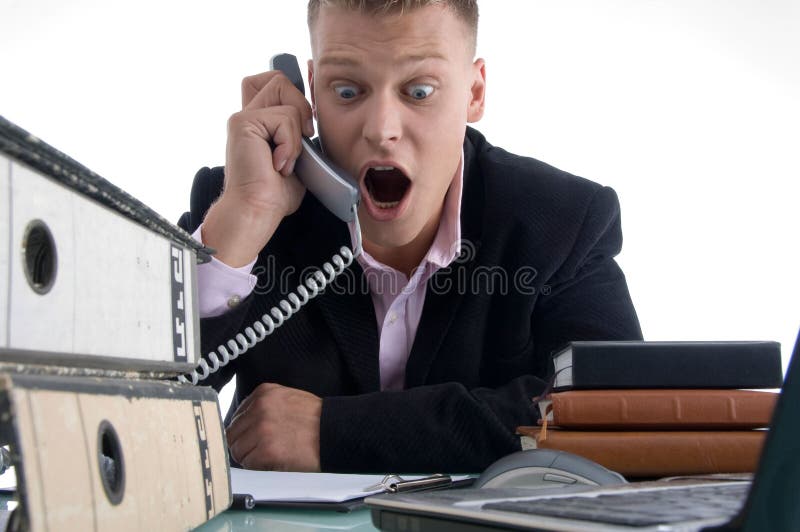 Shocked businessman holding receiver