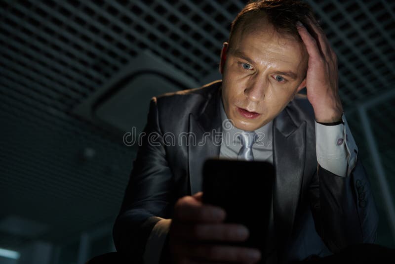 Shocked Businessman Reading Distressing News