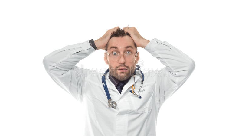 Shocked Doctor Man Doctor On White Background Looking At Camera Is At Loss Bewilderment And