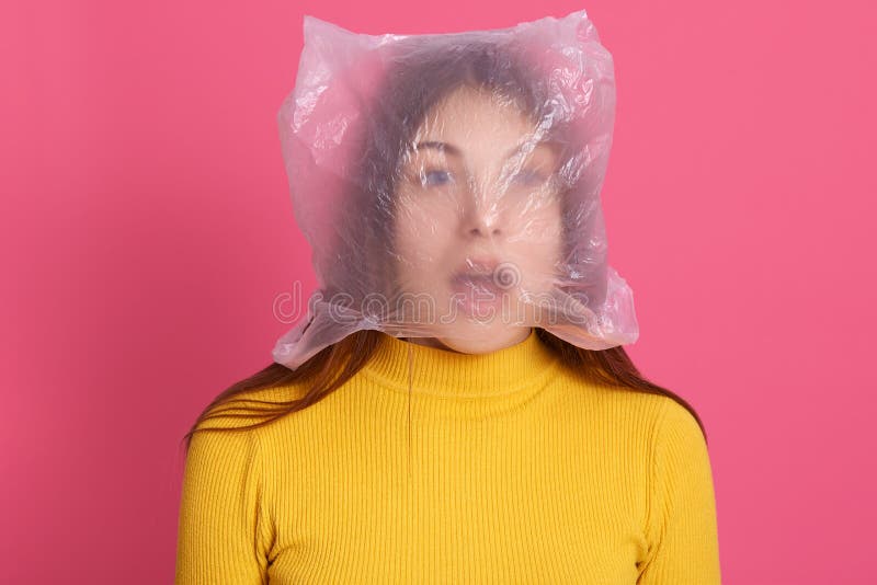 Shocked Female Wearing Shirt Posing with Plastic Bag on Her Head, Looks Shocked and Astonished, Keeping Mouth Widely Photo - Image of human, dump: 184848924