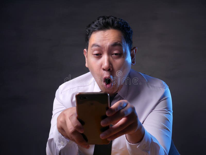 Shocked Happy Man Looking at Smart Phone royalty free stock photography Shocked Happy Man Looking at Smart Phone royalty free stock photography