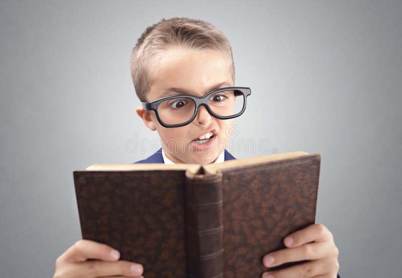 Shocked and surprised young executive businessman boy reading a book