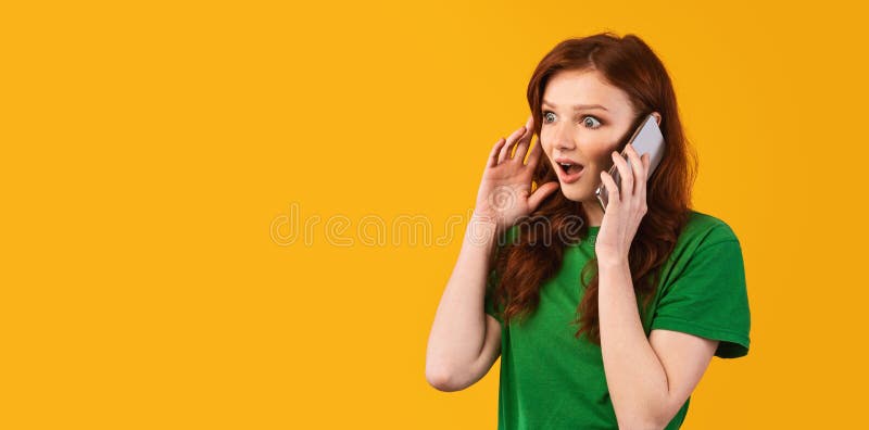 Shocked Teenager Girl Talking On Phone Standing On Yellow Background stock photo Shocked Teenager Girl Talking On Phone Standing On Yellow Background stock photo
