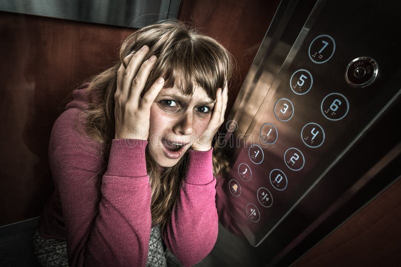 Shocked woman with claustrophobia in the moving elevator royalty free stock images Shocked woman with claustrophobia in the moving elevator royalty free stock images