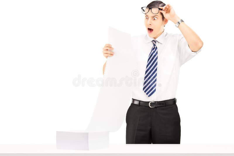 Shocked young businessman reading a document stock images