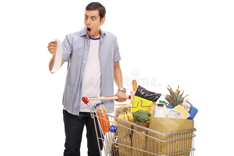 Shocked young man looking at a store receipt stock images