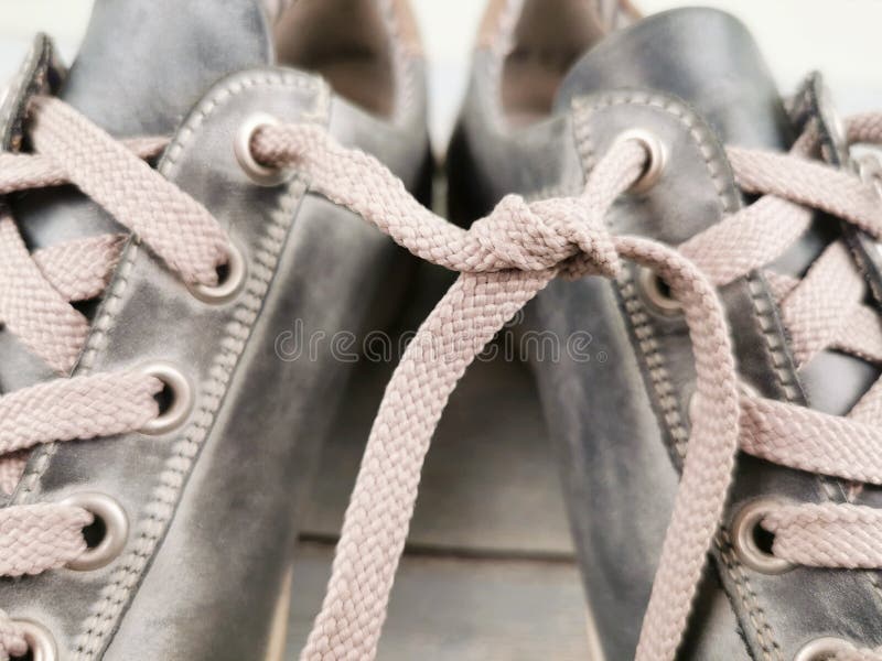 Shoelaces Tied Together on a Blurry Background, Close-up. April Fool`s ...