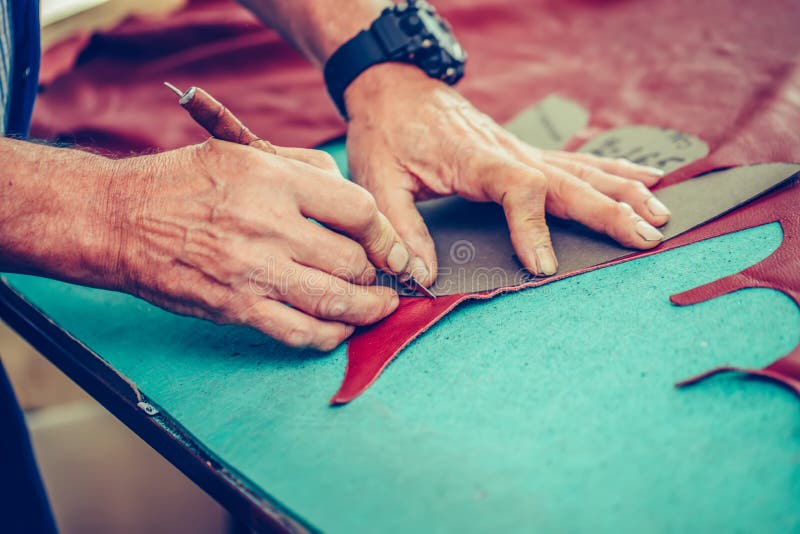 Shoemaker in a Footwear Industry, is Fixing Sole for Shoes Stock Photo