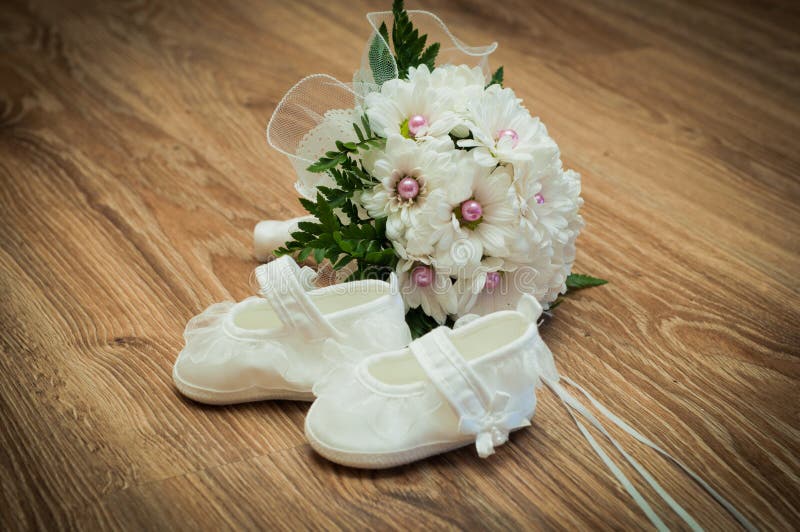 Shoes and bouquet on a wooden floor
