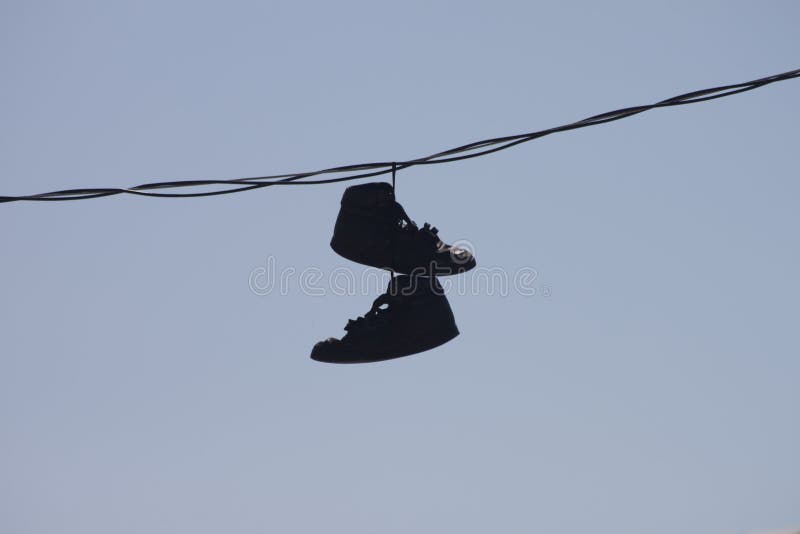 Shoes Hanging on Wire stock photo. Image of ghetto, times 20869900