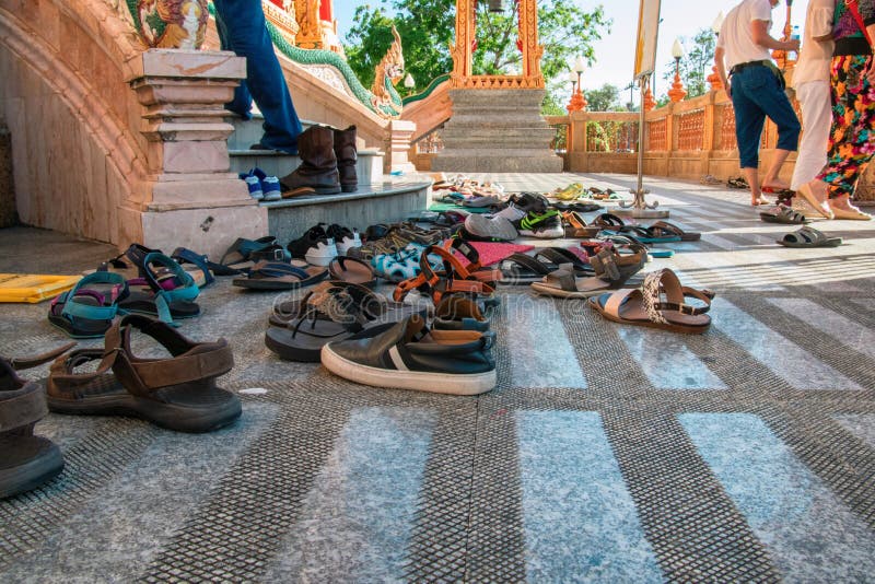 Shoes left at the entrance to the Buddhist temple. Concept of observing traditions, tolerance, gratitude and respect. stock photography Shoes left at the entrance to the Buddhist temple. Concept of observing traditions, tolerance, gratitude and respect. stock photography