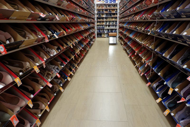 Shoes Rack that Forms a Straight Line in a Mall. Editorial Stock Image
