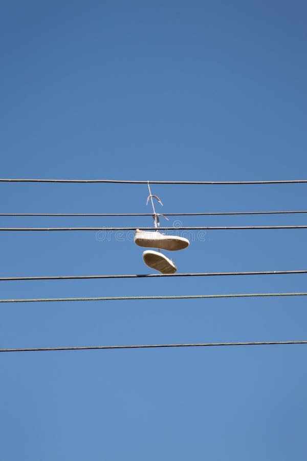 Shoes Tied Together and Hanging from Power Lines Stock Image - Image of
