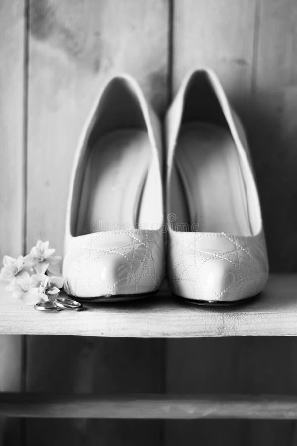 Shoes and wedding rings stock photography