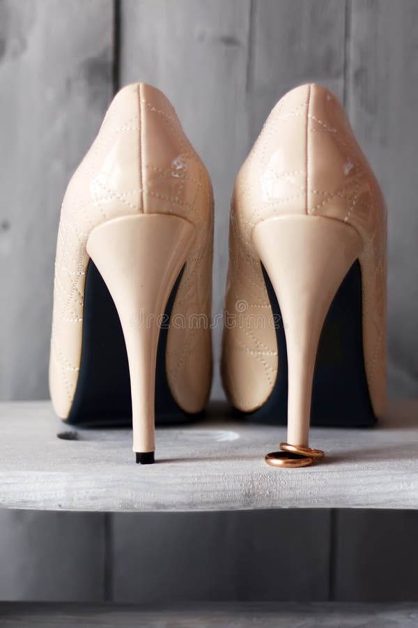 Shoes and wedding rings stock image