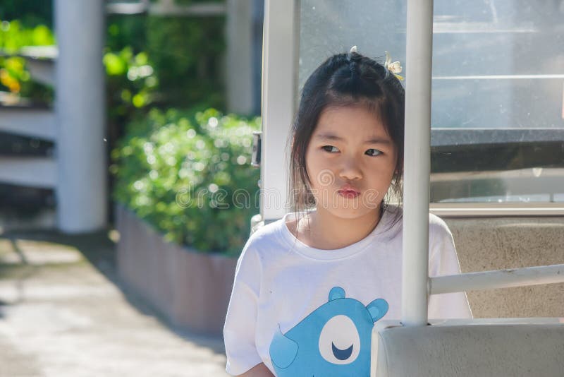 Shoot Asian little cute girl siting in goft car and thinking something. royalty free stock photo Shoot Asian little cute girl siting in goft car and thinking something. royalty free stock photo