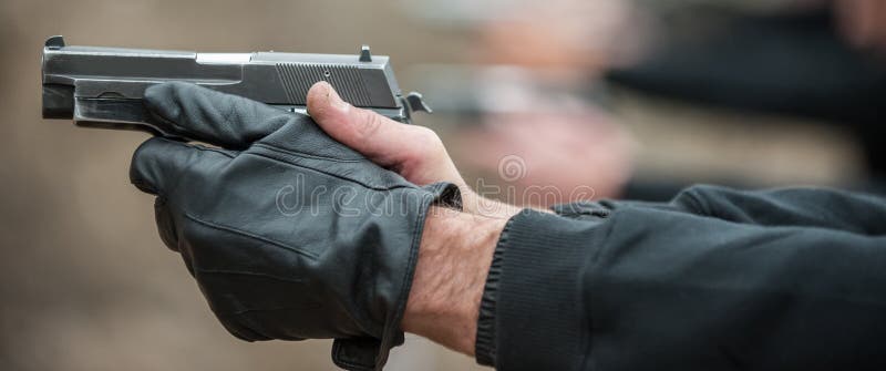 Shooter in row group of people hold gun and shooting stock photography
