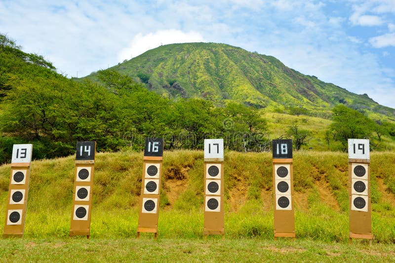 Shooting range targets in line under a mountain