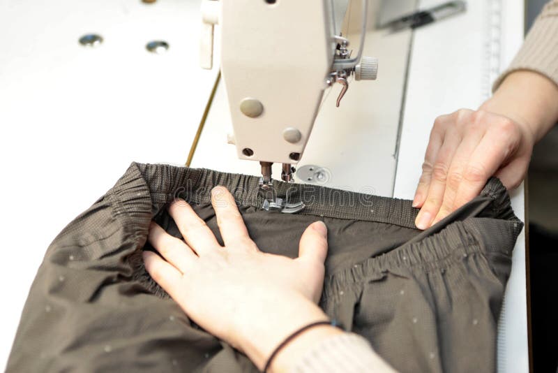 Shop for Tailoring. a Woman Creates Clothes on a Sewing Machine ...