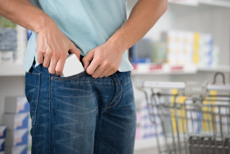 Shoplifter Putting Packet In Pocket royalty free stock photography
