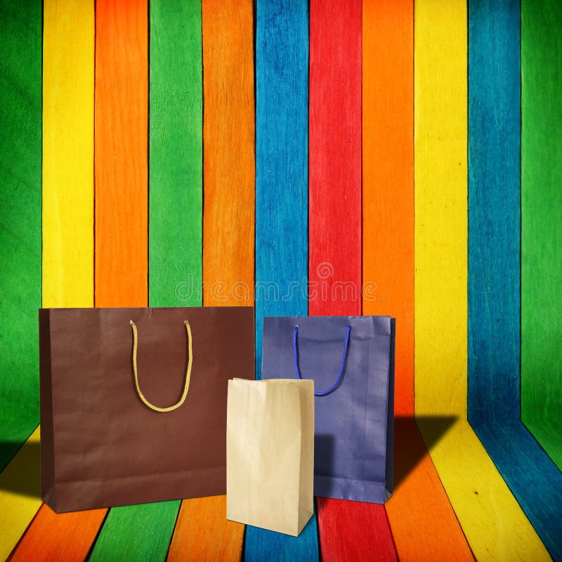 Shopping bags on colorful wood