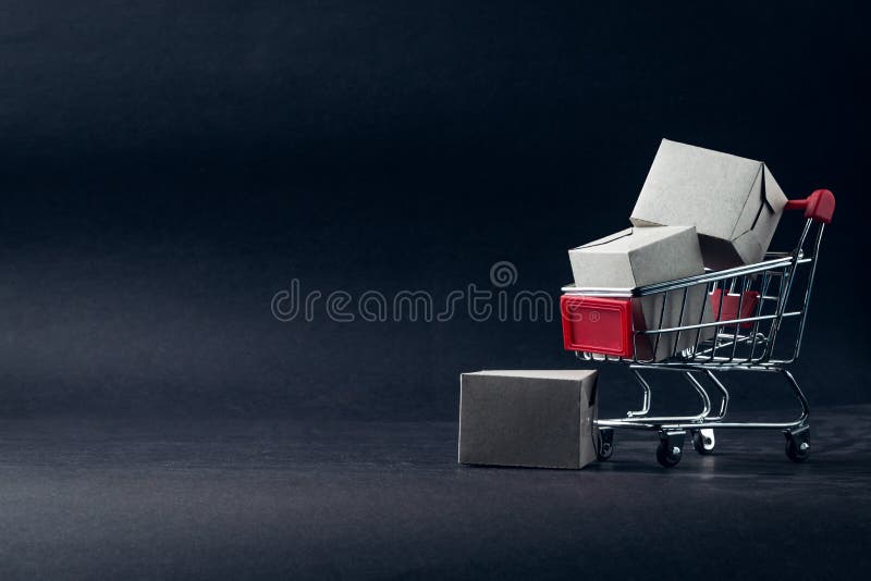 Shopping cart and box on dark background, business, shopping concept