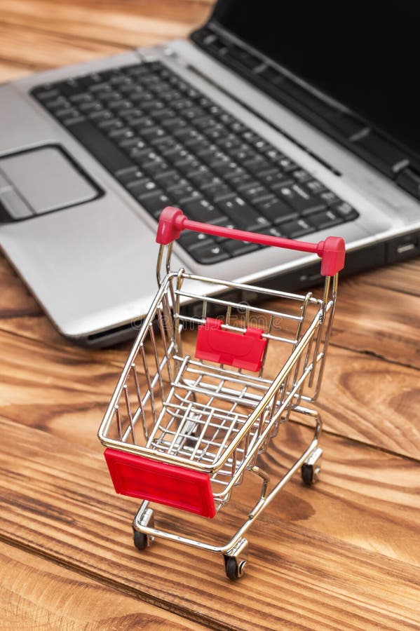 Shopping Cart and Laptop on the Table. Online Shopping and